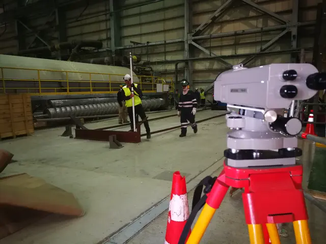 Nivel óptico y personal con mira durante un montaje industrial